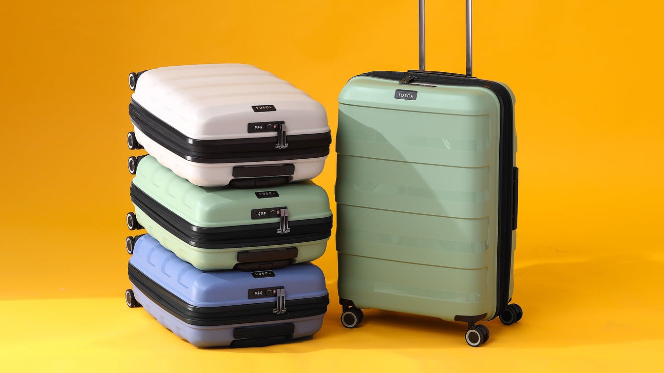 Stack of suitcases on a yellow background